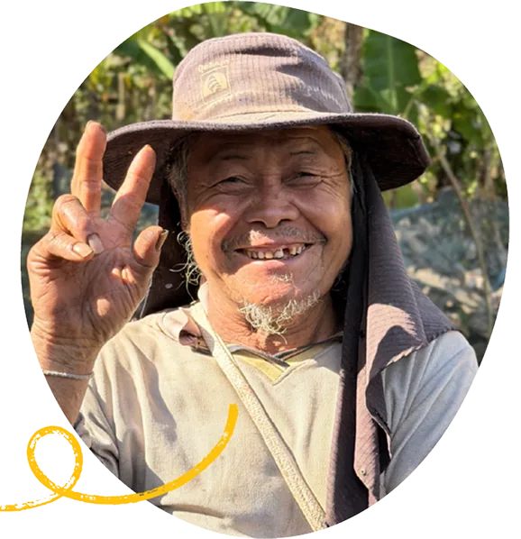A community member smiling in the field